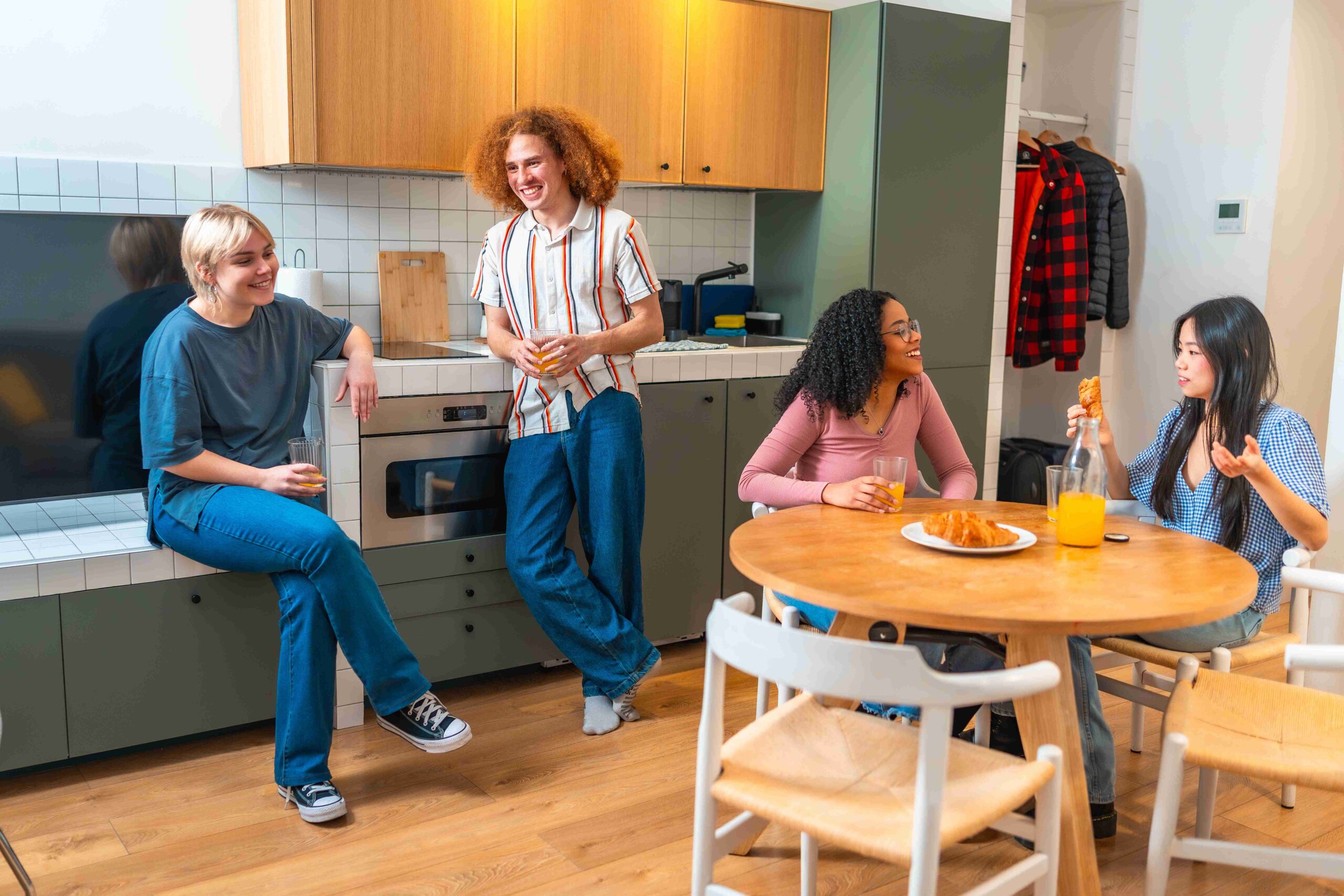 Friends chatting and relaxing together in a kitchen