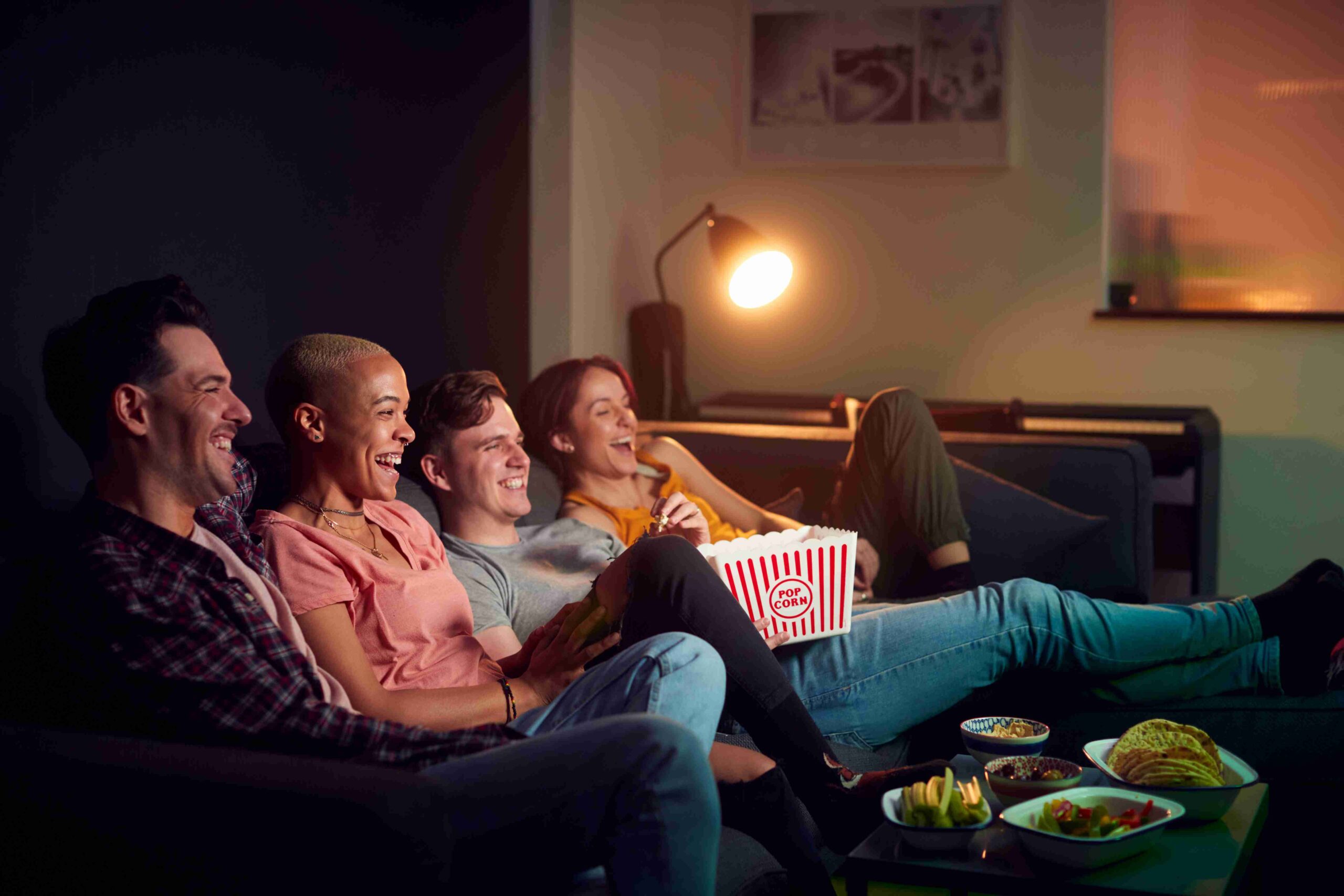 Friends relaxing and laughing on a couch