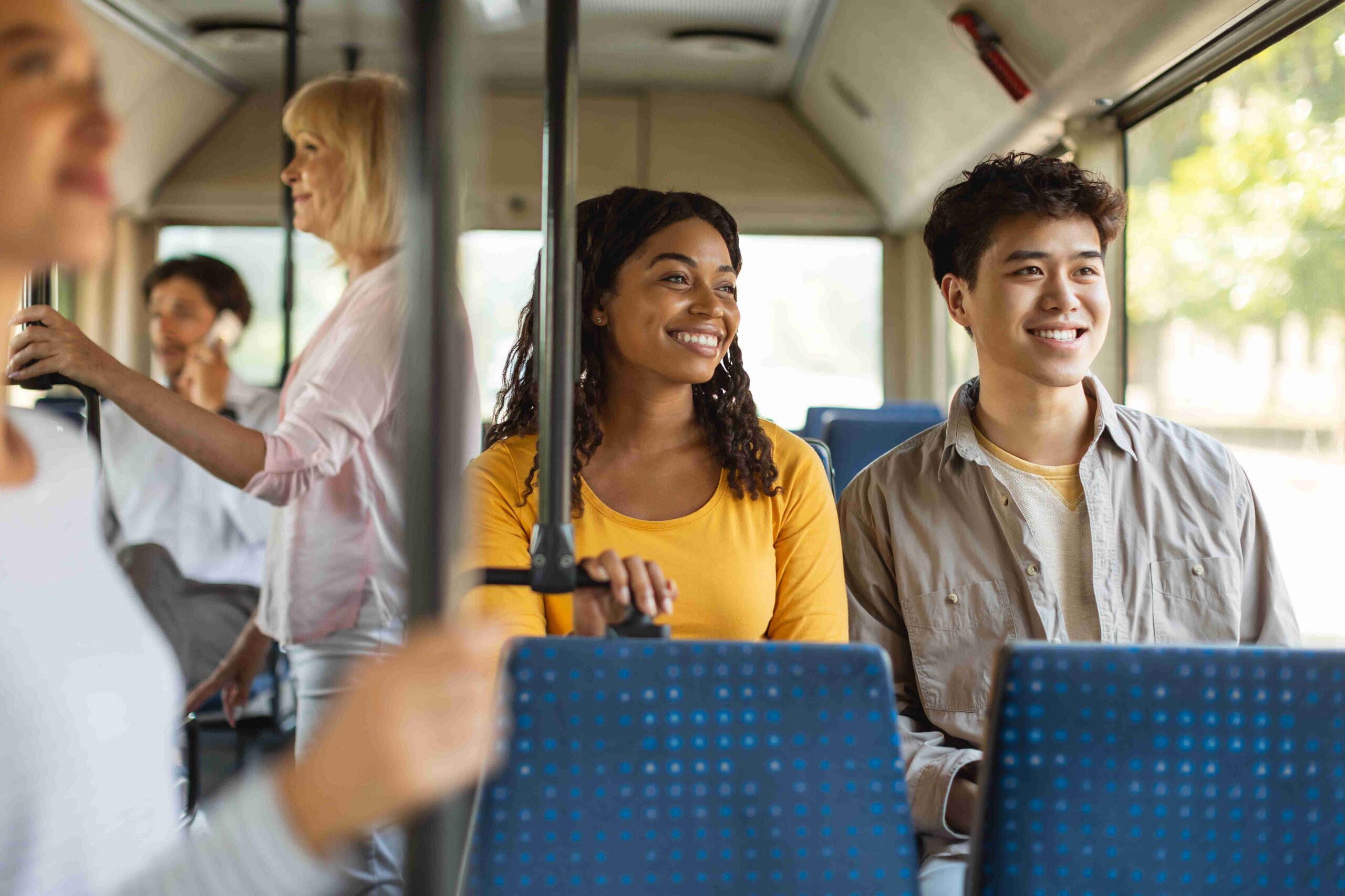People riding the bus in a city setting