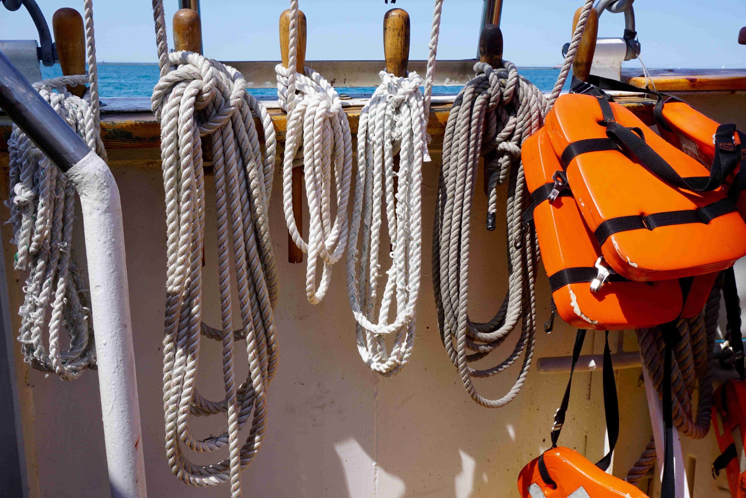 Safety gear and nautical ropes on a sailing vessel