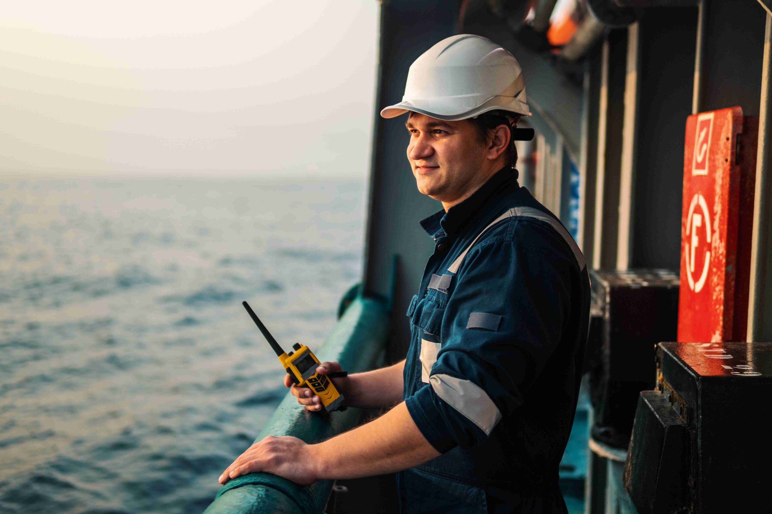 Ship officer on deck with a radio