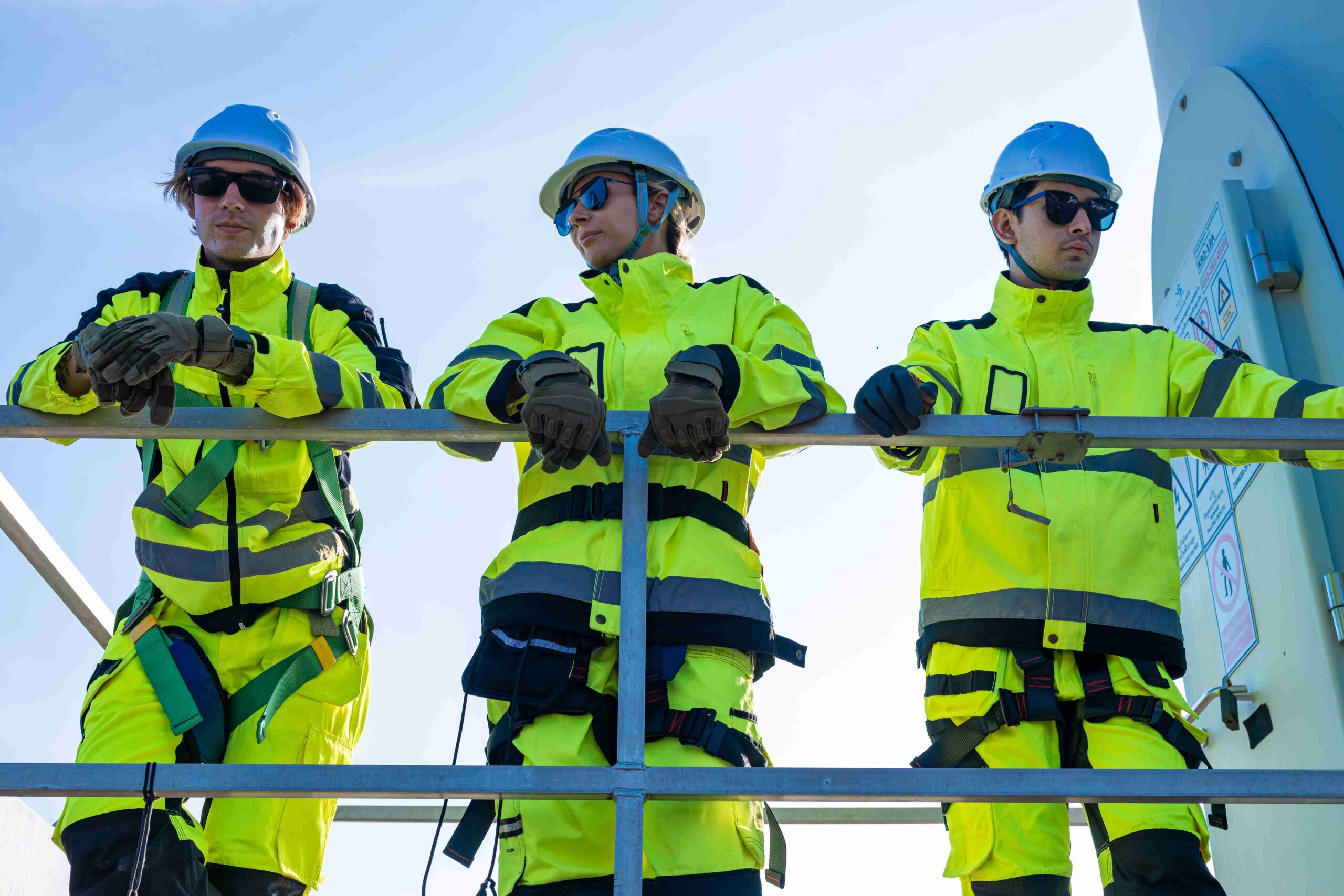 Technicians in protective gear at work